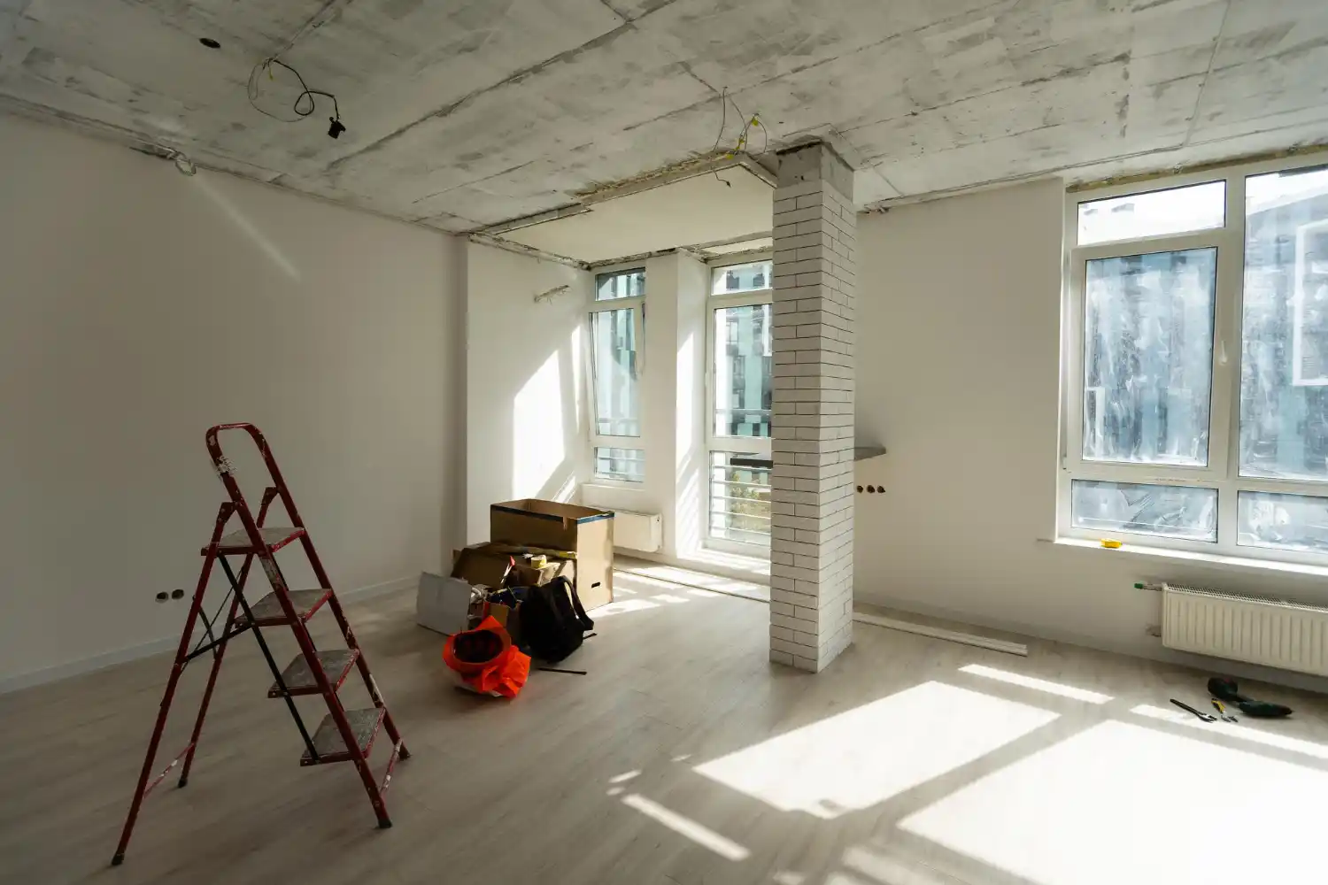 Licensed professionals installing electrical and plumbing systems during basement renovation